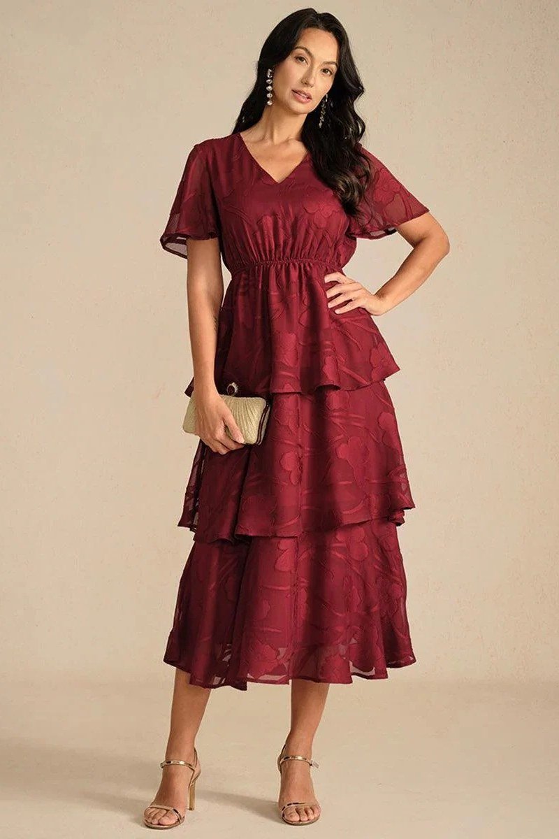 Woman in burgundy tiered midi dress with heels
