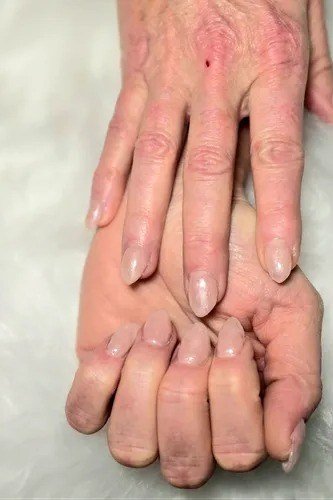 Pink nude nails on older hands for women over 50