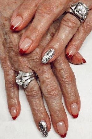 Nude nails with silver glitter and red tip accents