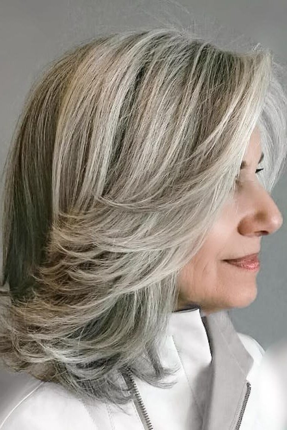 Icy silver straight layered medium-length hairstyle, side view, for women over 50