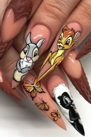 Pink stiletto nails with Thumper portrait swirls and glitter fall nails