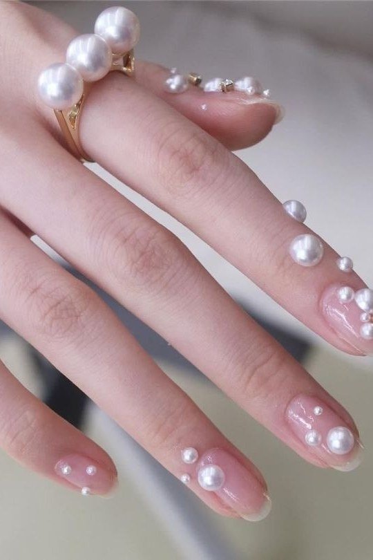 Sheer pink nails with dewdrop pearl art