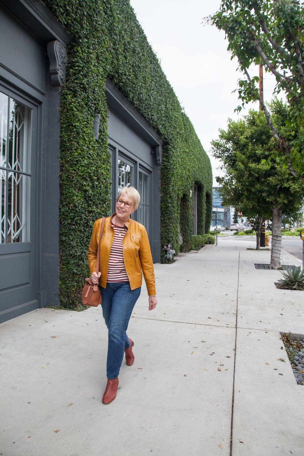 Mustard jacket with jeans and red boots fall outfit idea for women over 60