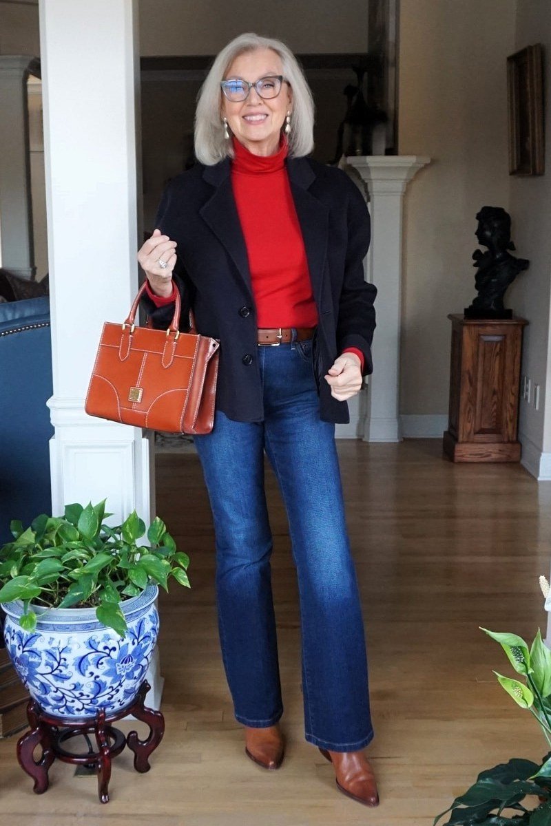 Black blazer over red turtleneck with blue jeans and rust handbag