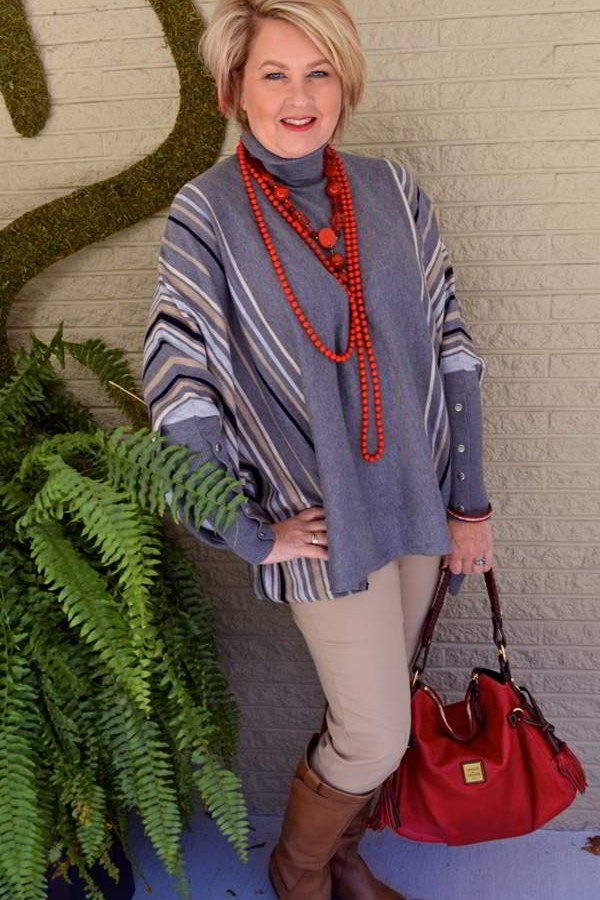 grey poncho, red beads and tan trousers fall outfit for women over 60
