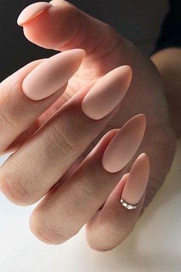 Matte Nude Almond with Ring - elegant nude nail design for women over 60
