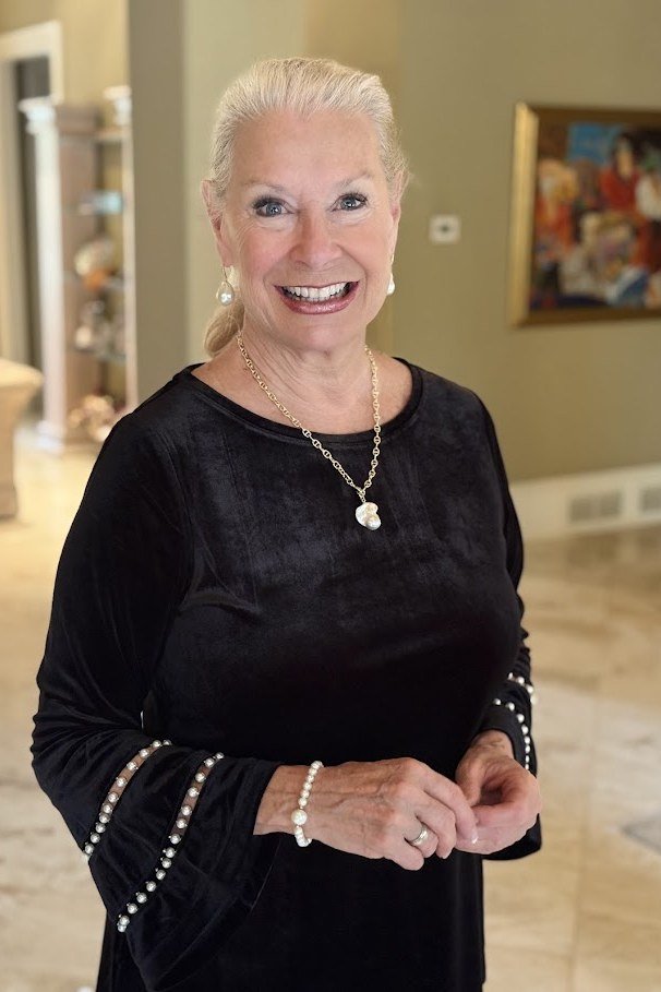 holiday evening outfit for women over 60: black velvet top with pearl button cuffs