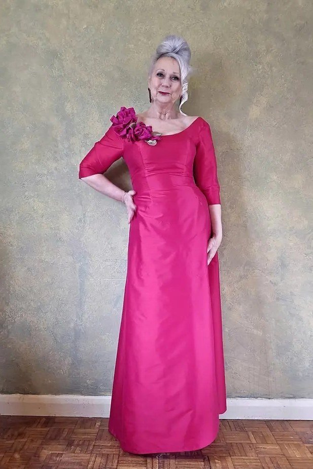 Fuchsia sheath gown with floral shoulder detail for women over 60