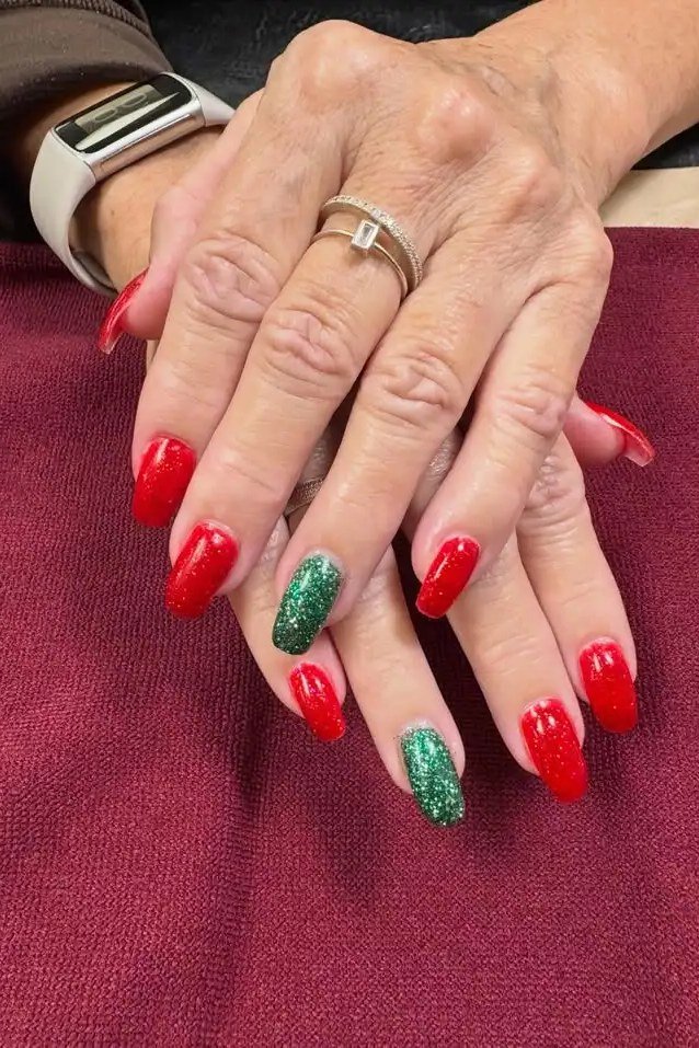Red with green glitter accent nail, mature hands - Christmas nail design for older women