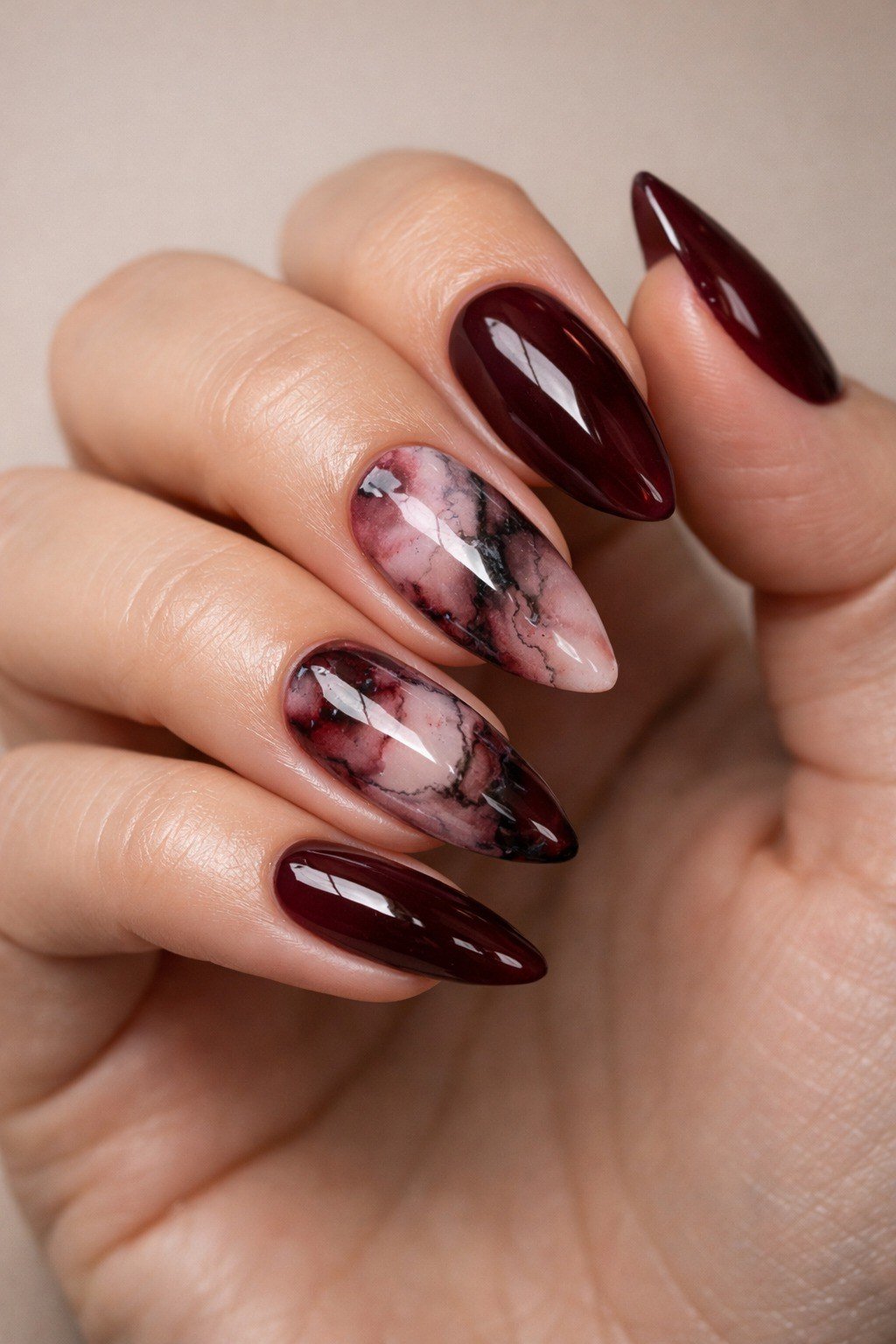 Glossy burgundy marble almond nails for women over 50