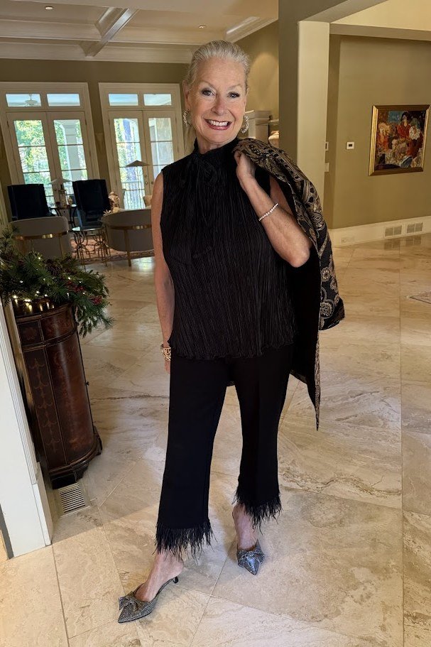 holiday evening outfit for women over 60: black sequin fringe top with black pants