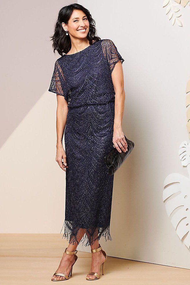 Blonde woman in navy lace midi dress with heels