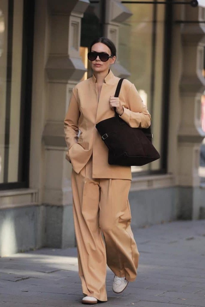 Camel long coat with a chambray shirt, wide-leg jeans, and tan loafers, effortless weekend outfit for women over 40
