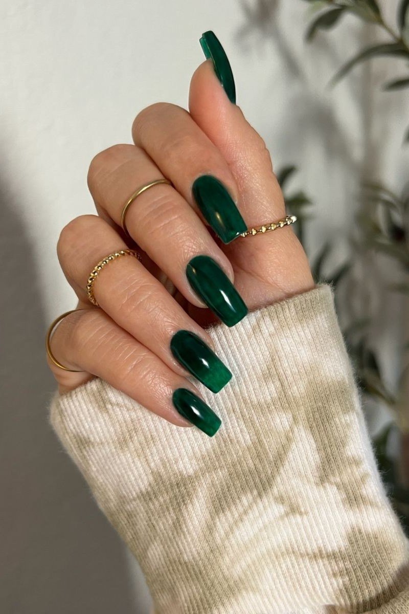 Emerald green almond glossy, elegant fall nail design for women over 40