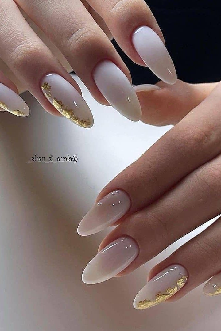 Milky white almond nails with metallic gold tips
