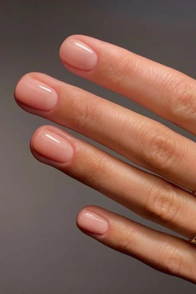 Sheer Pink Almond with a Gold Ring - short nude nail idea for women over 50