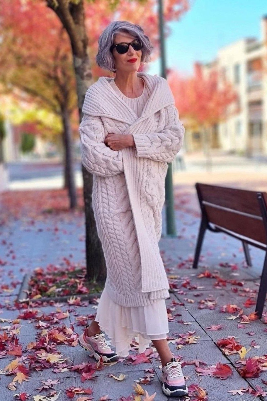 Cream cable-knit shawl coat with a white midi dress and white sneakers, sweet weekend outfit for women over 40