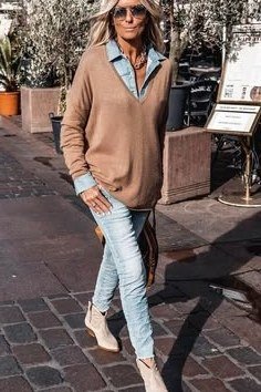 Casual fall outfit for women over 60: black moto jacket, blush sweater, dark jeans