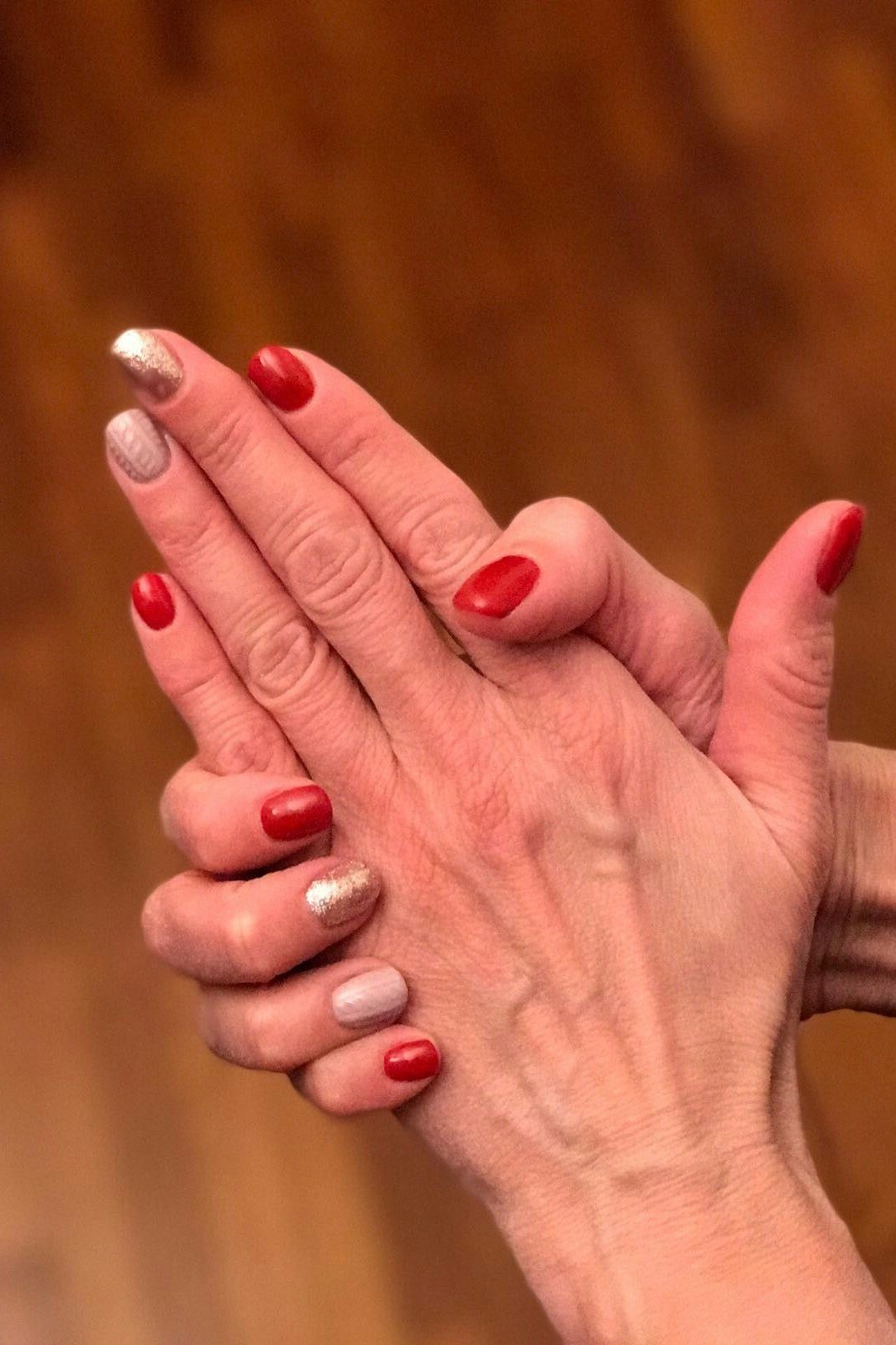 Red, nude and gold mix on mature hands - Christmas nail design for older women