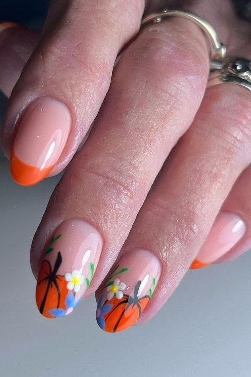 Peach nails with pumpkin art, fall nail design for older women