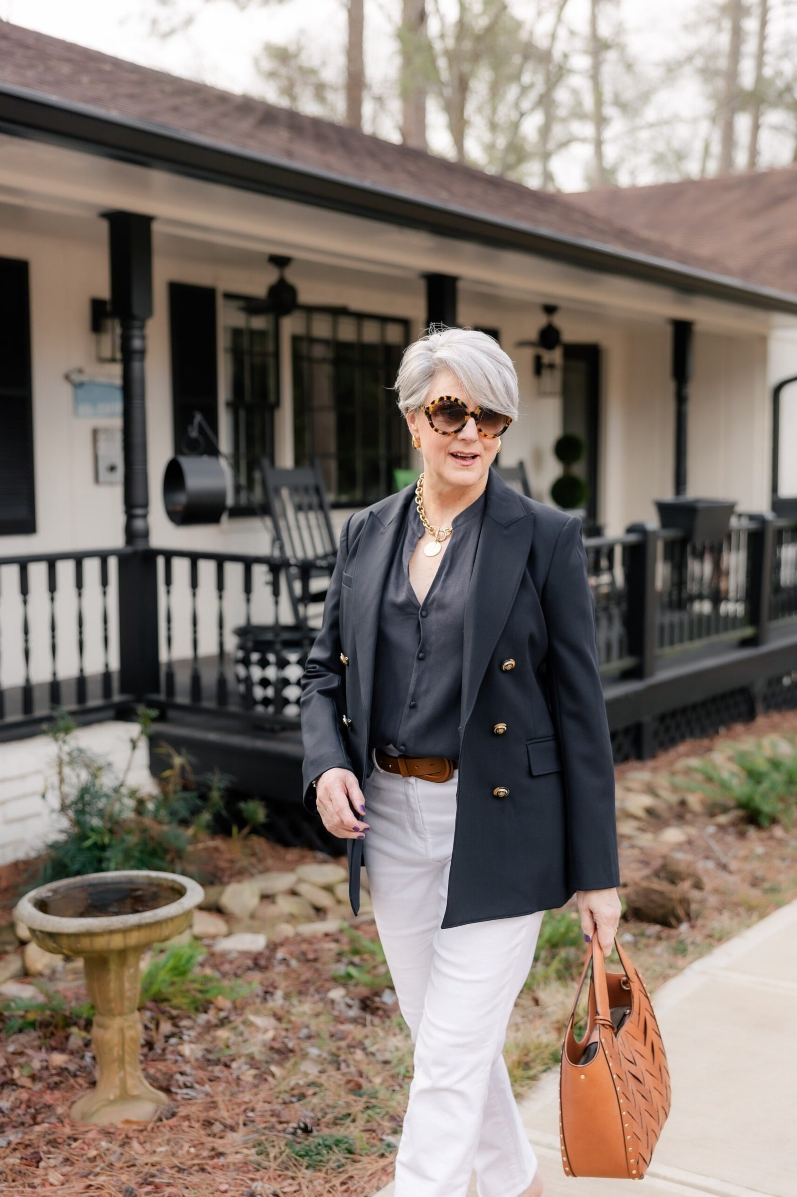 Navy blazer with dark top and white jeans for women over 60