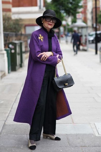 Vivid purple knee coat with black wide-leg trousers for women over 50