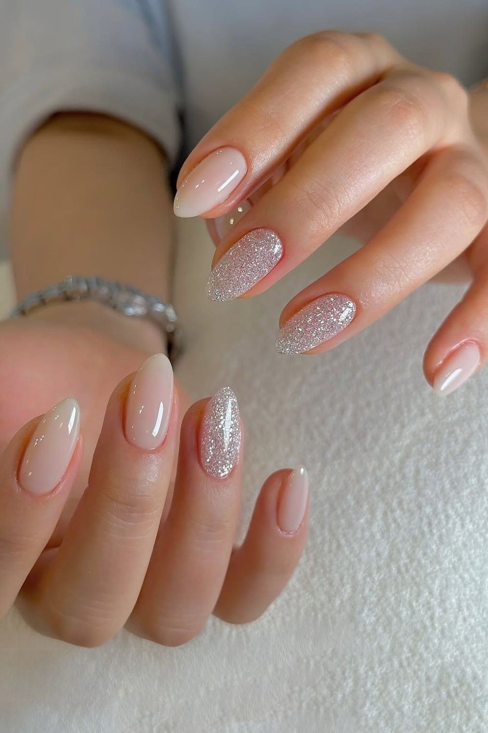 Milky white nails with fine silver glitter accents