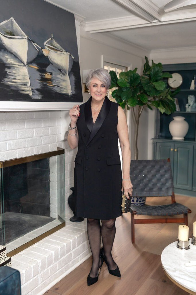 holiday evening outfit for women over 60: black sleeveless cocktail dress
