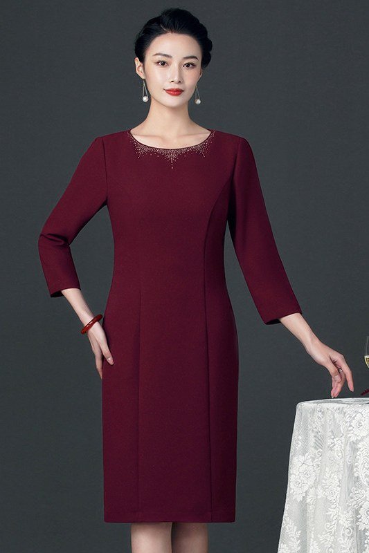 burgundy three-quarter-sleeve cocktail dress at an evening table