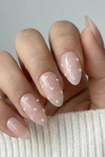 Almond nails with scattered pearl dots