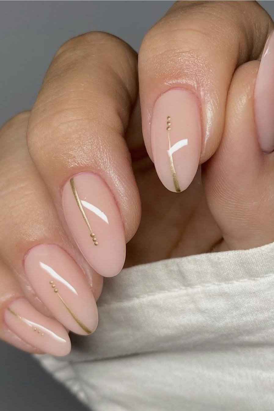 Nude Almond Nails with Gold Line Art - flattering nail polish shade that hides veins for women over 50