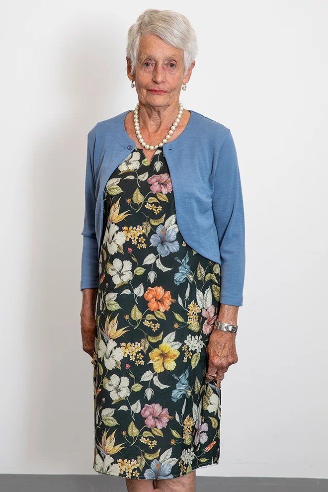 dark floral dress with blue shrug for women over 60