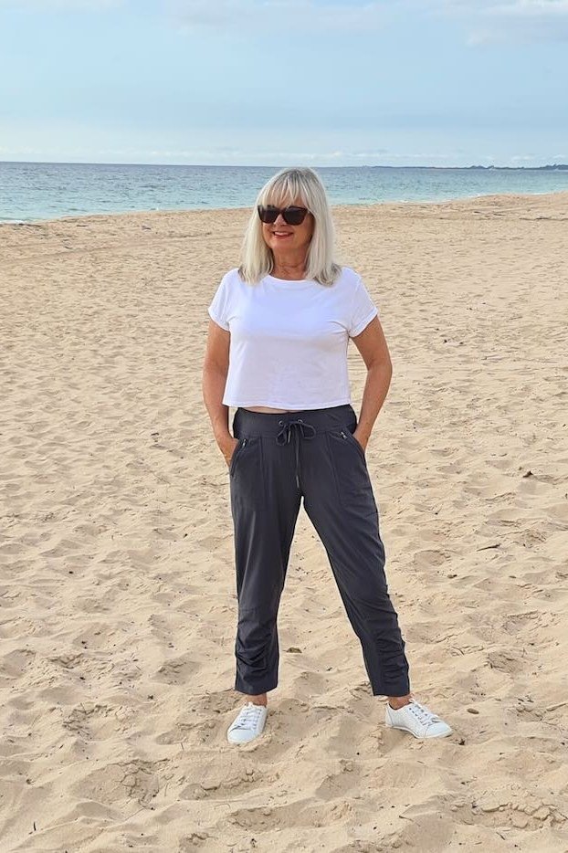 Easy casual outfit idea for women over 50: white tee and navy wide pants, older woman everyday style