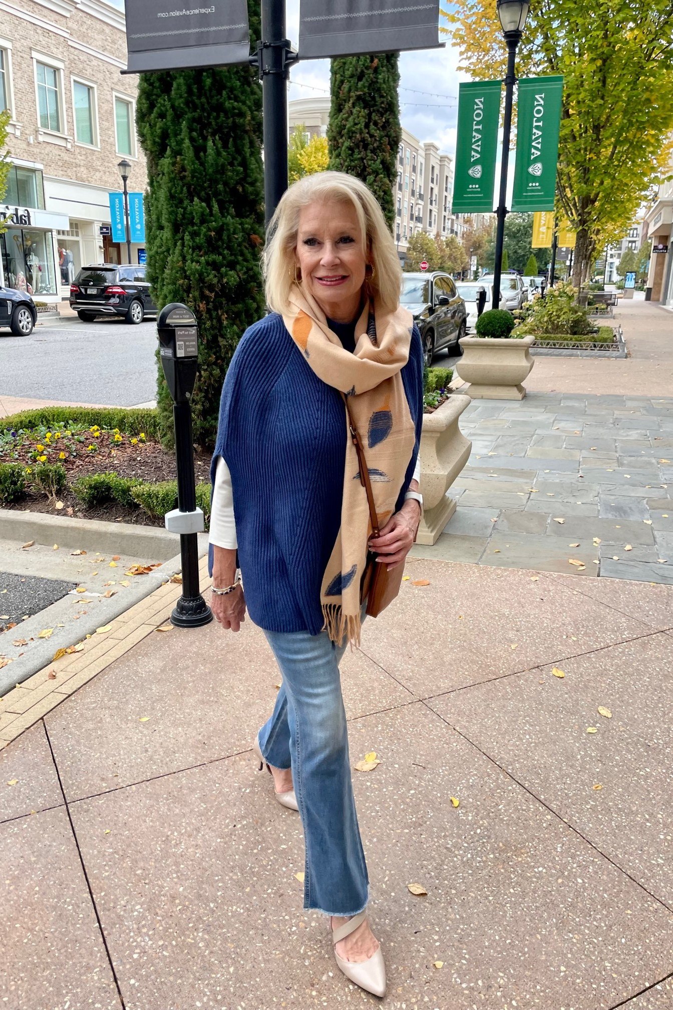 navy sweater, tan scarf and light jeans fall outfit for women over 60