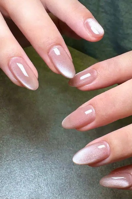 Sheer Pink Pearl Cat Eye Nails - Sheer pink with pearl like magnetic shimmer covers these short, oval nails.