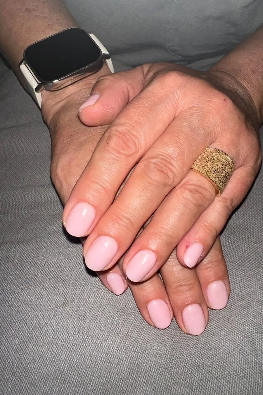 Pink nude nails with smartwatch for women over 50