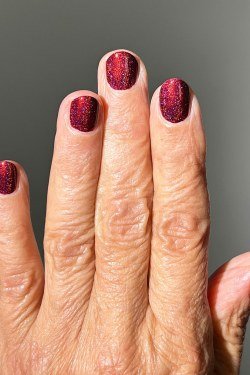 Red Glitter on Mature Hands nail design for women over 40