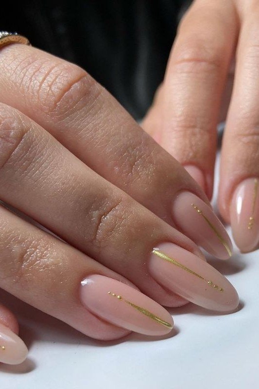 Nude Almond Nails with Gold French Tips - flattering nail polish shade that hides veins for women over 50
