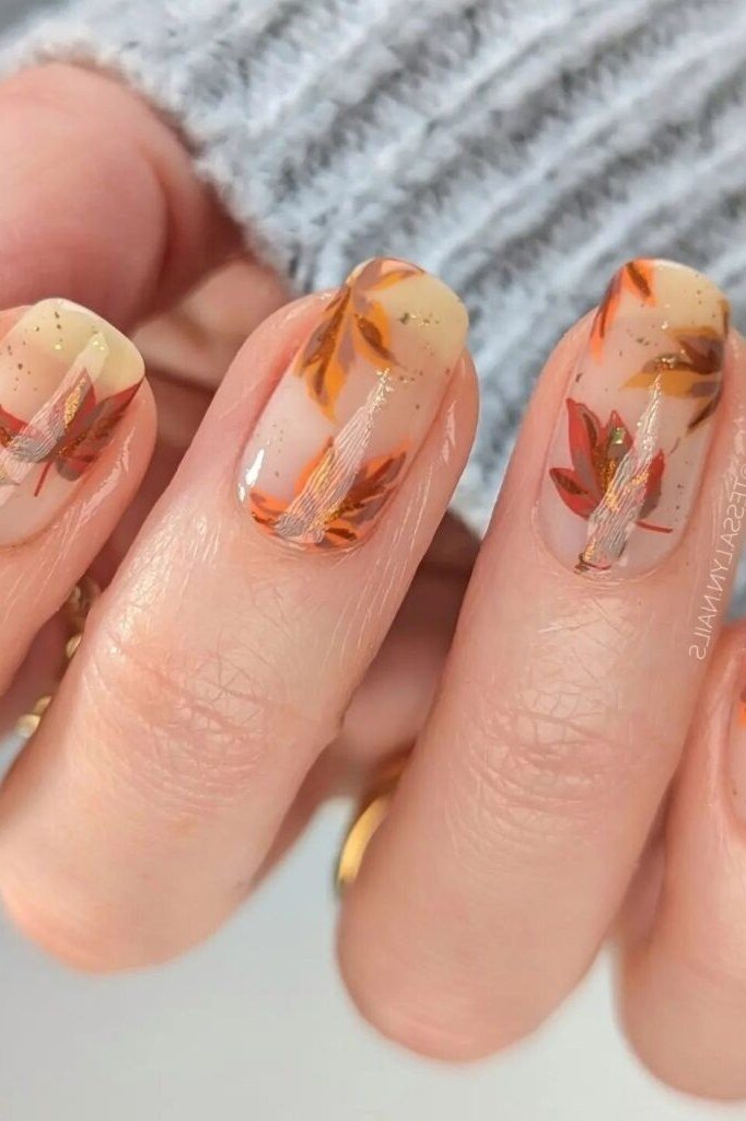 Sheer nails with autumn leaf art, fall nail design for older women