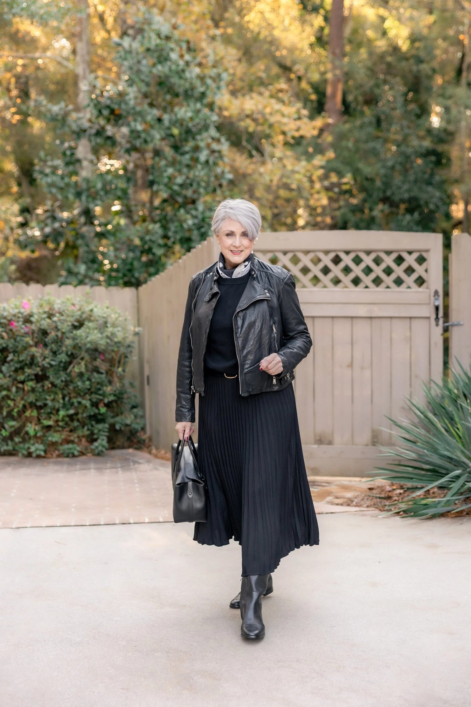 Black Leather Jacket With a Black Pleated Midi Skirt and Boots, smart casual outfit for women over 50
