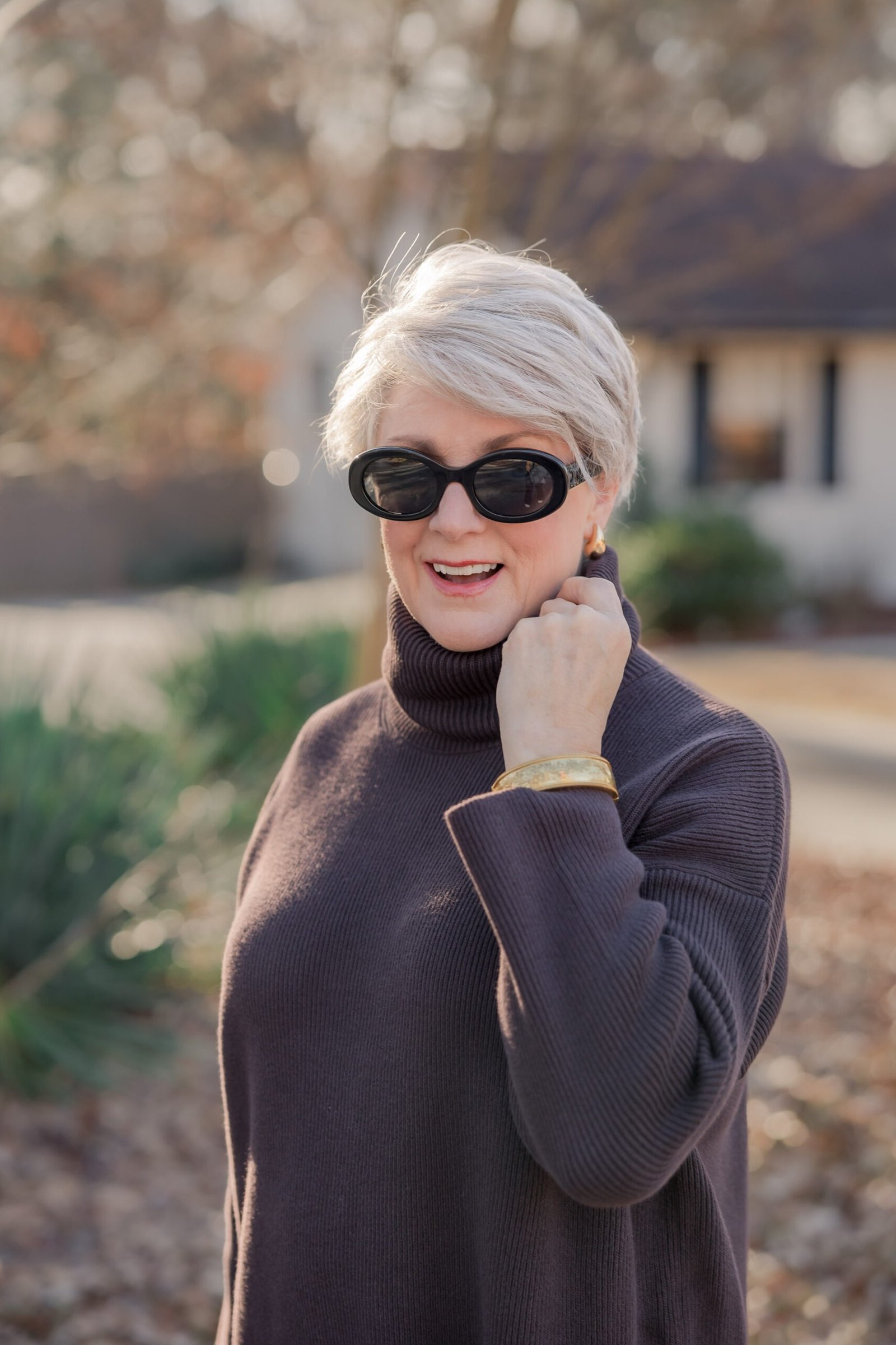 Black turtleneck sweater dress with sunglasses for women over 50