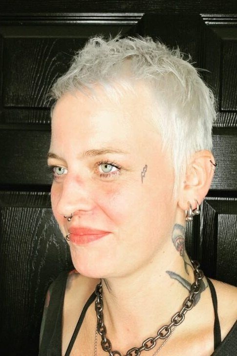 Platinum Pixie with Tattoos - bold edgy pixie haircut for women over 50