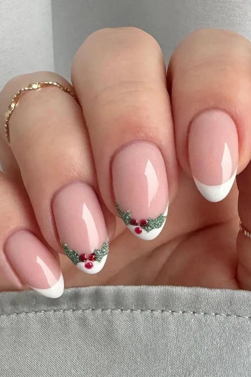 nude nails with white french tips and holly accents
