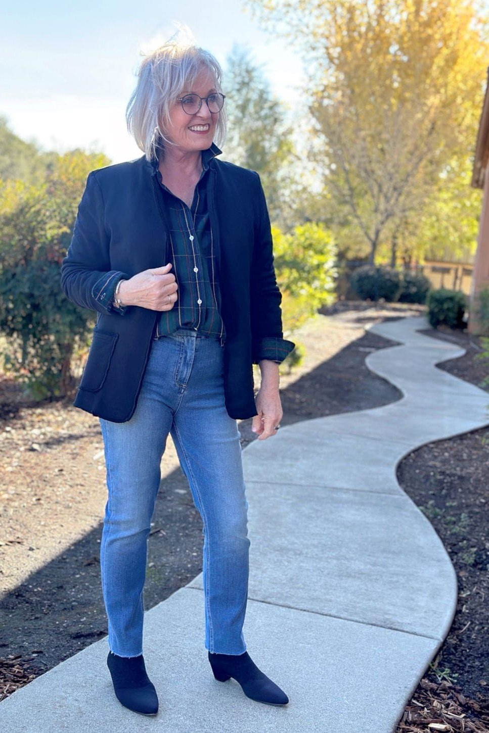 Navy blazer over denim shirt with jeans and boots for women over 60
