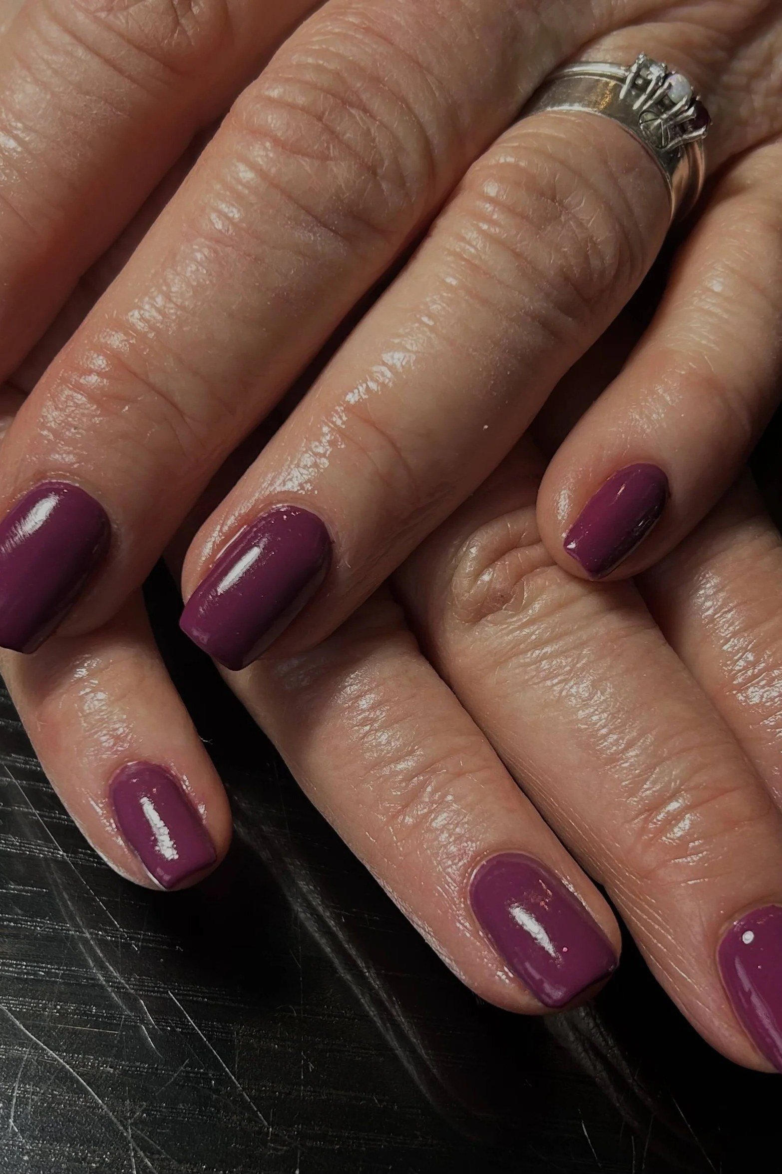Deep Plum Gloss on Mature Hands - fall nail color idea for women over 60