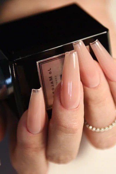 Nude Coffin with Perfume Bottle - elegant nude nail design for women over 60