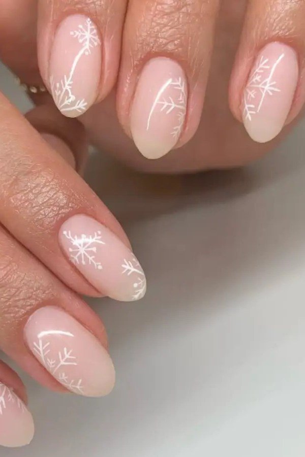 Milky pink nails with white snowflake nail art