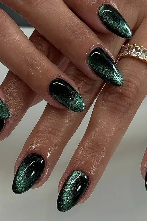 Emerald Cat Eye Nails - Deep emerald green with black tones and strong magnetic shimmer covers these medium length almond nails.