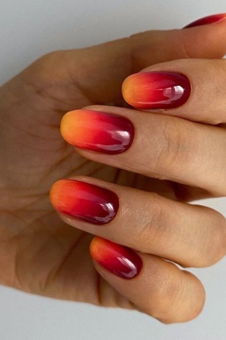 Burgundy Red Almond Ombre - Deep burgundy melts into glowing red orange on these medium almond nails.