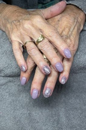 Lavender nails with silver glitter accents